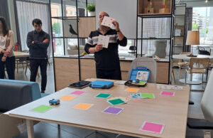 Ponente mostrando tarjetas de programación a los asistentes durante el taller