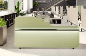 Mostrador de recepción verde con textura en relieve en un espacio de coworking
